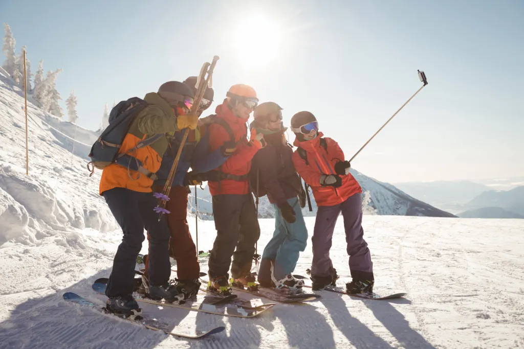group-skiers-taking-selfie-mobile-phone